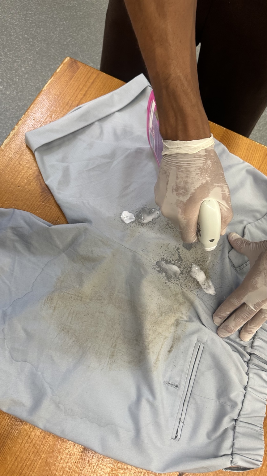 Careful stain treatment on a garment